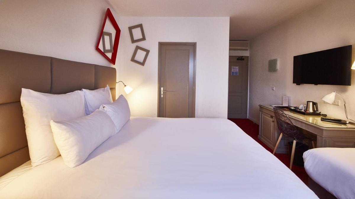 Un ou plusieurs lits dans un hébergement de l'établissement Best Western Plus Au cheval Blanc à Mulhouse