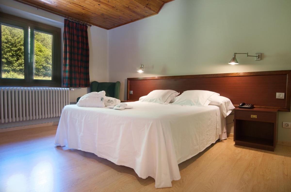 Cama o camas de una habitación en Hotel Manantial