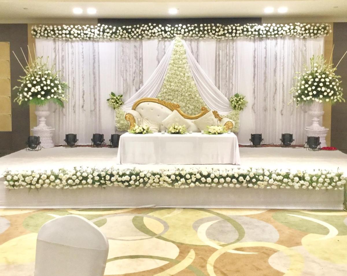 a wedding altar with a bed with flowers at The Suryaa New Delhi in New Delhi a wedding altar with a bed with flowers at The Suryaa New Delhi in New Delhi