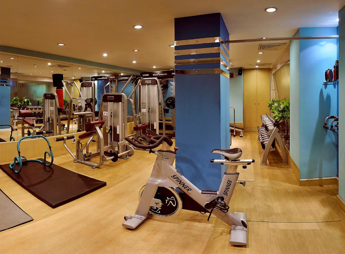a fitness room with a gym with a exercise bike at The Suryaa New Delhi in New Delhi a fitness room with a gym with a exercise bike at The Suryaa New Delhi in New Delhi