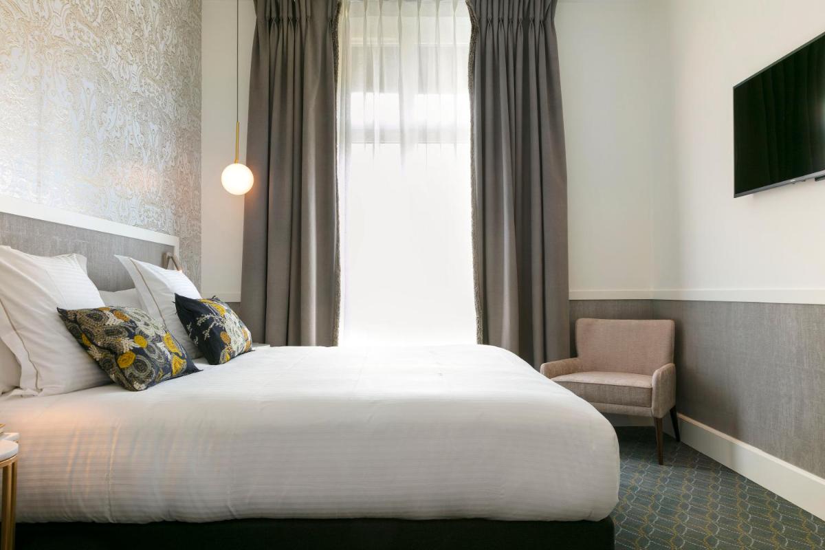 Un ou plusieurs lits dans un hébergement de l'établissement Continental Hotel