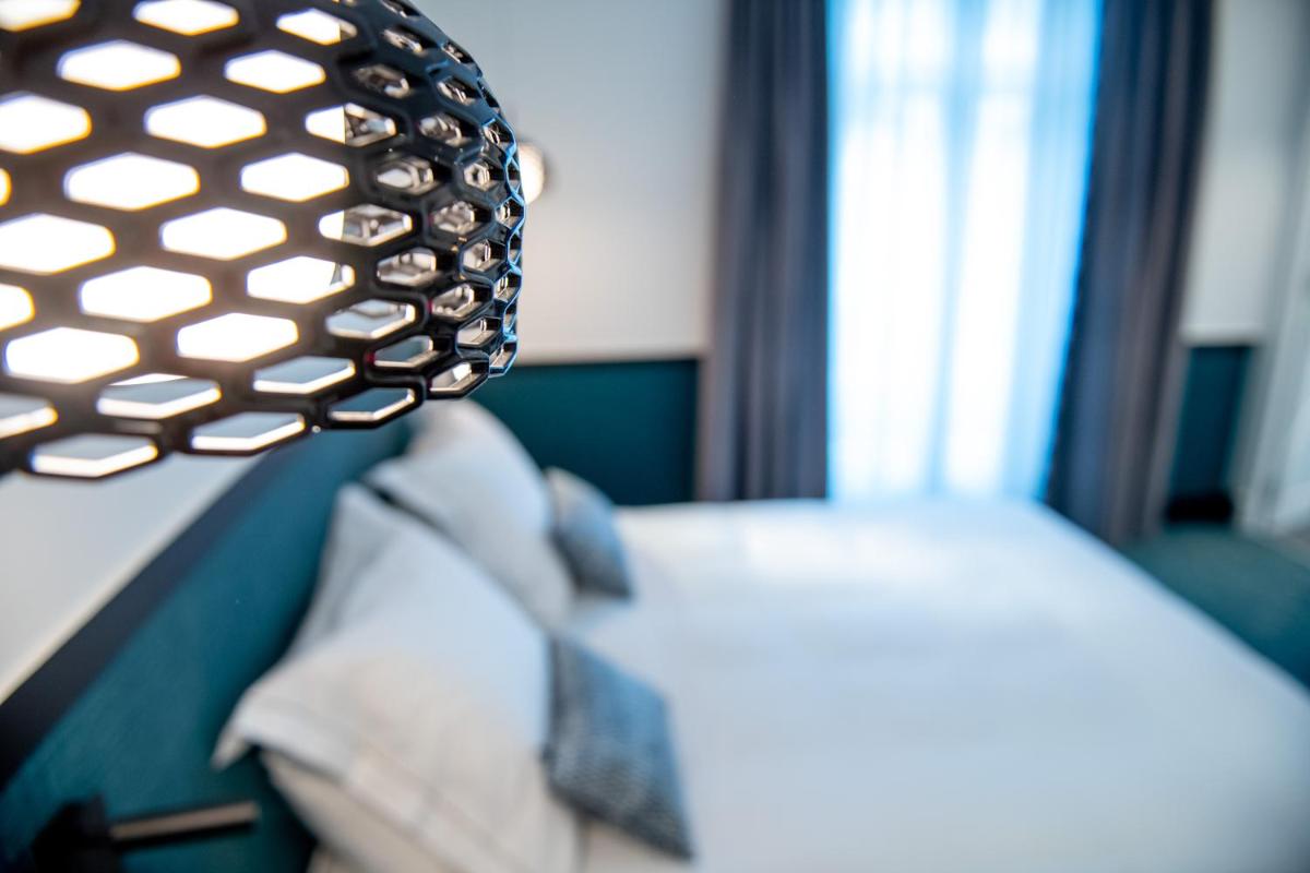 Un ou plusieurs lits dans un hébergement de l'établissement Continental Hotel
