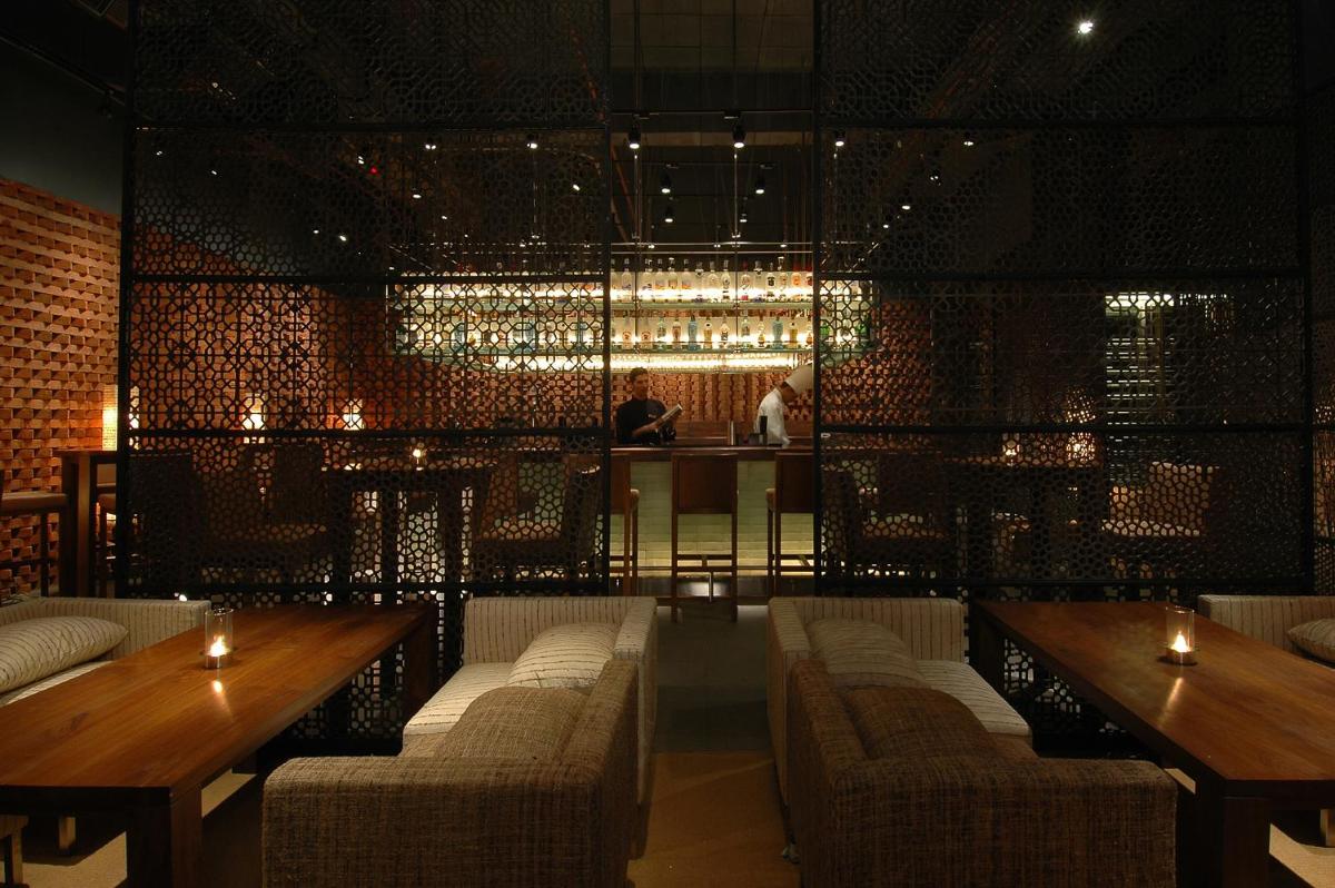 a restaurant with couches and tables and a bar at President - IHCL SeleQtions in Mumbai