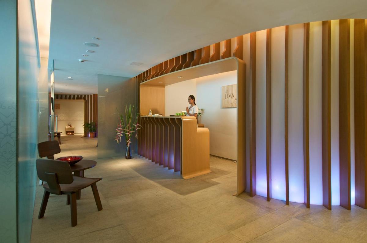 a woman standing at a counter in a lobby at President - IHCL SeleQtions in Mumbai