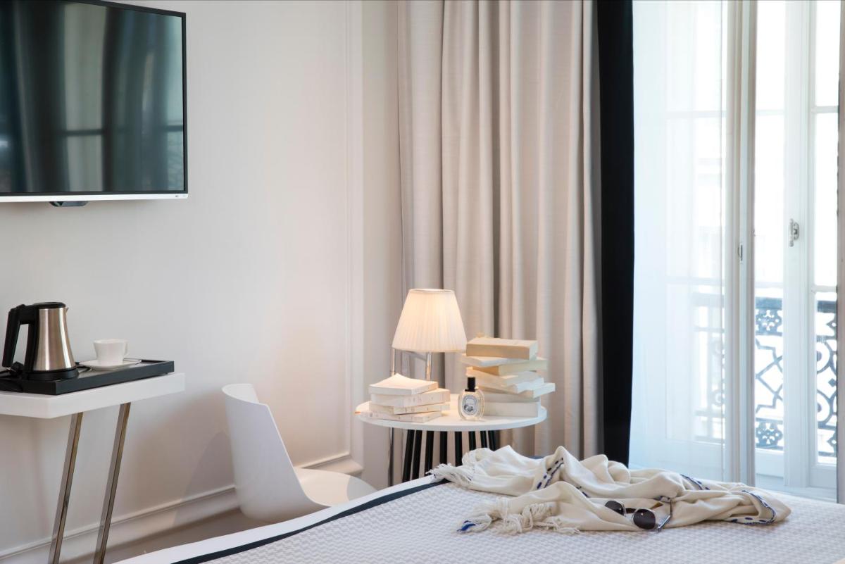 Un ou plusieurs lits dans un hébergement de l'établissement Hôtel R de Paris - Boutique Hotel