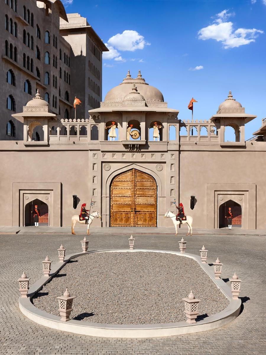 a building with a gate with horses in front of it at Fairmont Jaipur in Jaipur