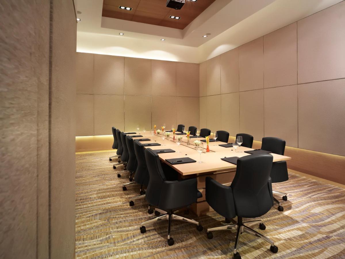 a large conference room with a long table and chairs at Taj City Centre Gurugram in Gurgaon