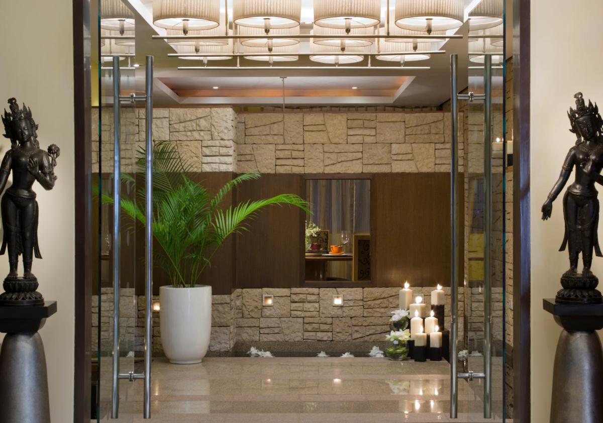 a lobby with a mirror and candles in a room at Blue Diamond Pune IHCL SeleQtions in Pune