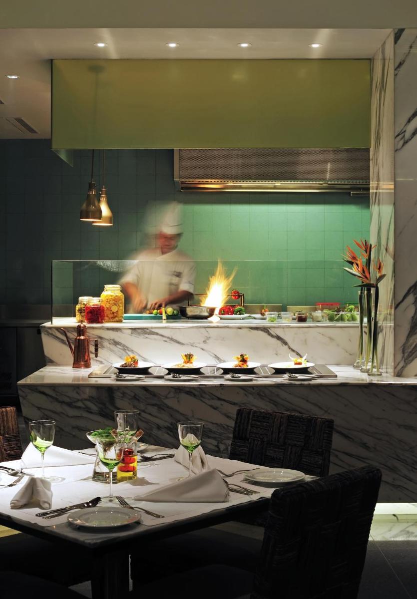 a chef in the kitchen preparing food in a restaurant at Taj Bengal in Kolkata