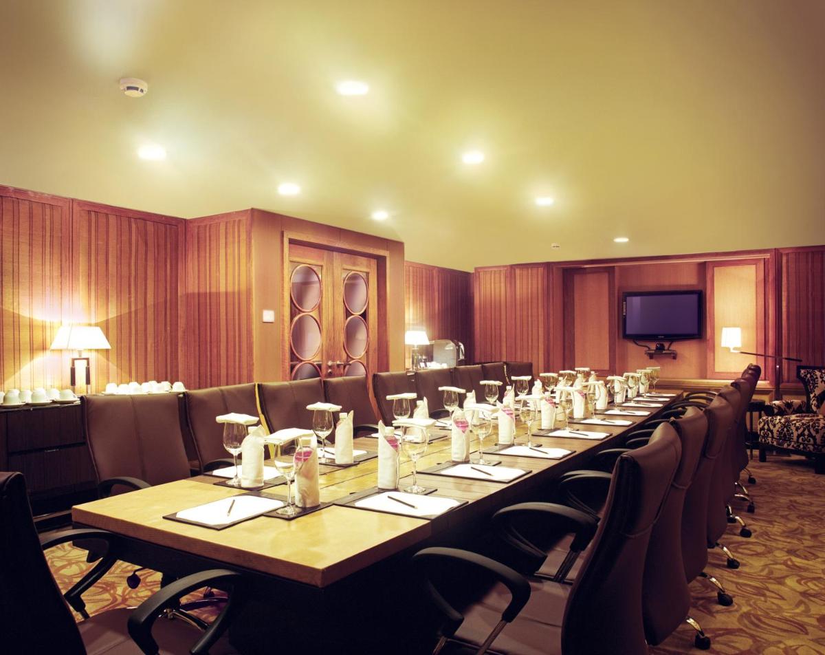 a large conference room with a long table and chairs at Taj Bengal in Kolkata