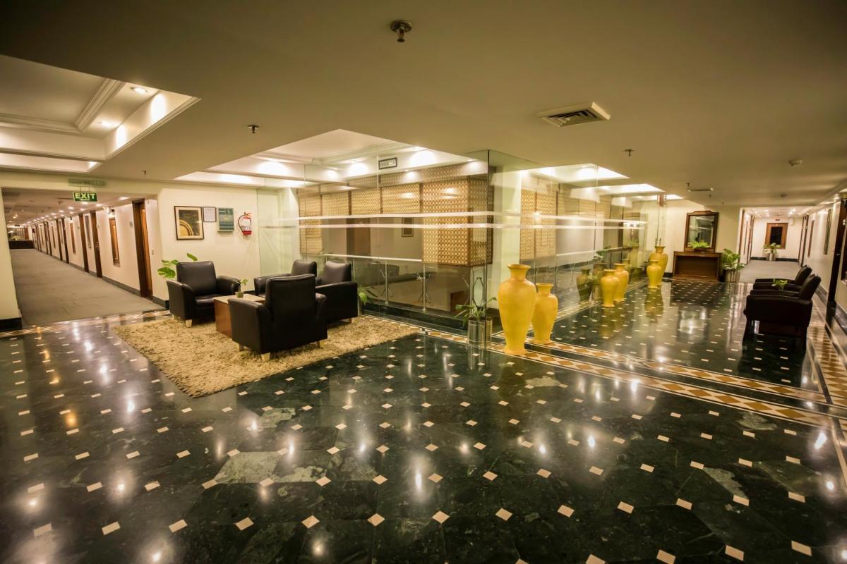 a lobby with couches and chairs in a building at The Piccadily in Lucknow