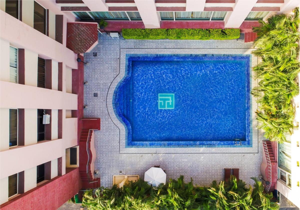 an overhead view of a swimming pool in a building at The Piccadily in Lucknow