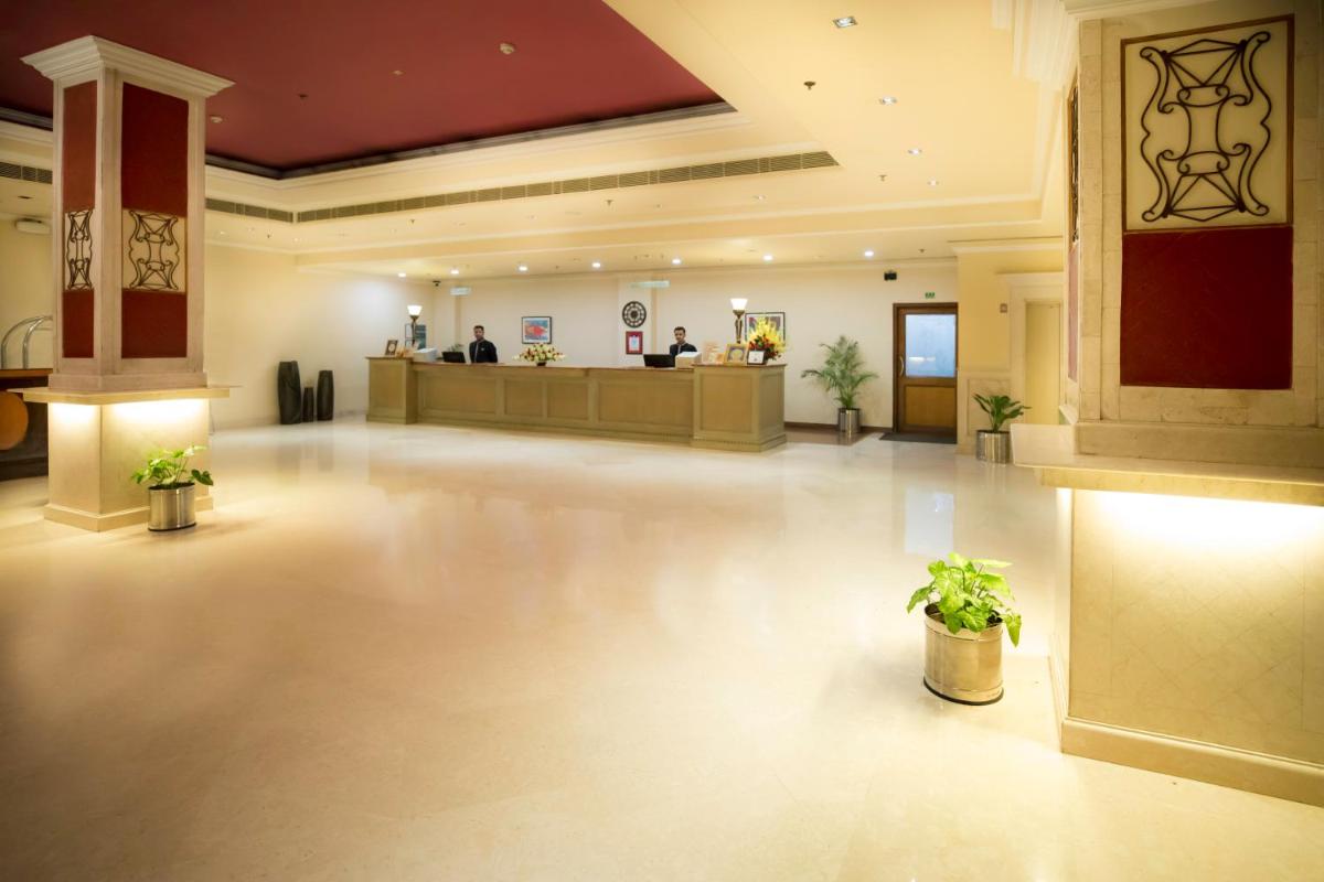 a lobby with a waiting room and a reception at The Piccadily in Lucknow