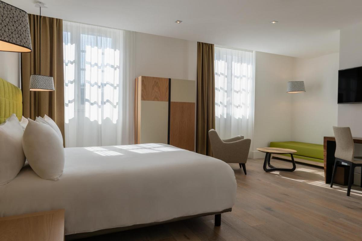 Un ou plusieurs lits dans un hébergement de l'établissement Hôtel Ginkgo - SPA Biloba