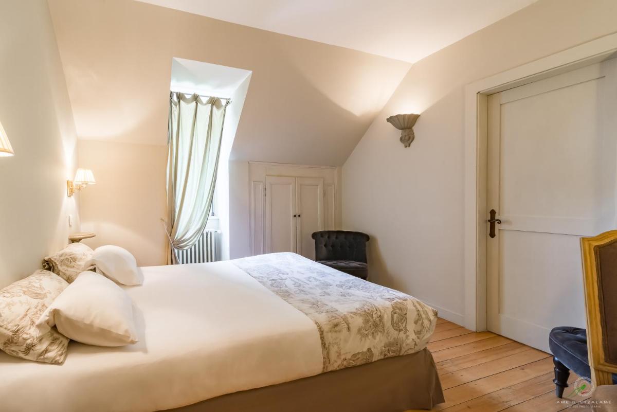 Un ou plusieurs lits dans un hébergement de l'établissement Hôtel Restaurant Spa Le Sauvage
