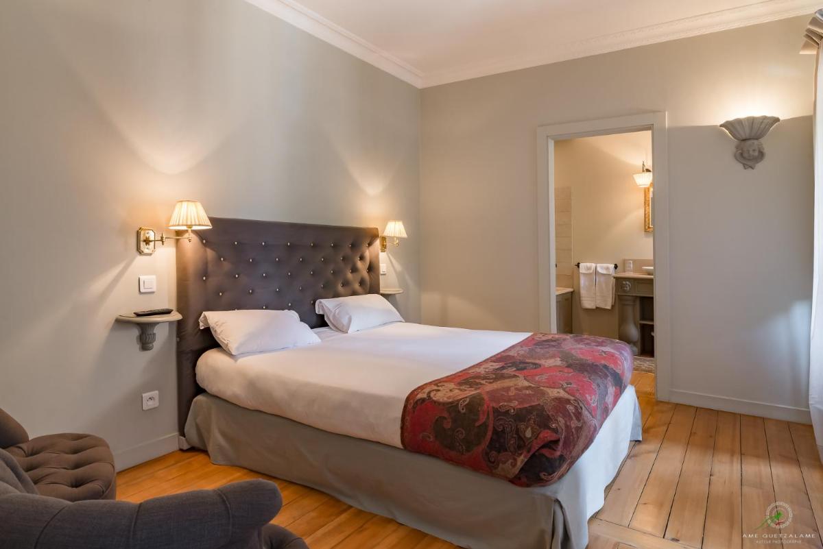 Un ou plusieurs lits dans un hébergement de l'établissement Hôtel Restaurant Spa Le Sauvage