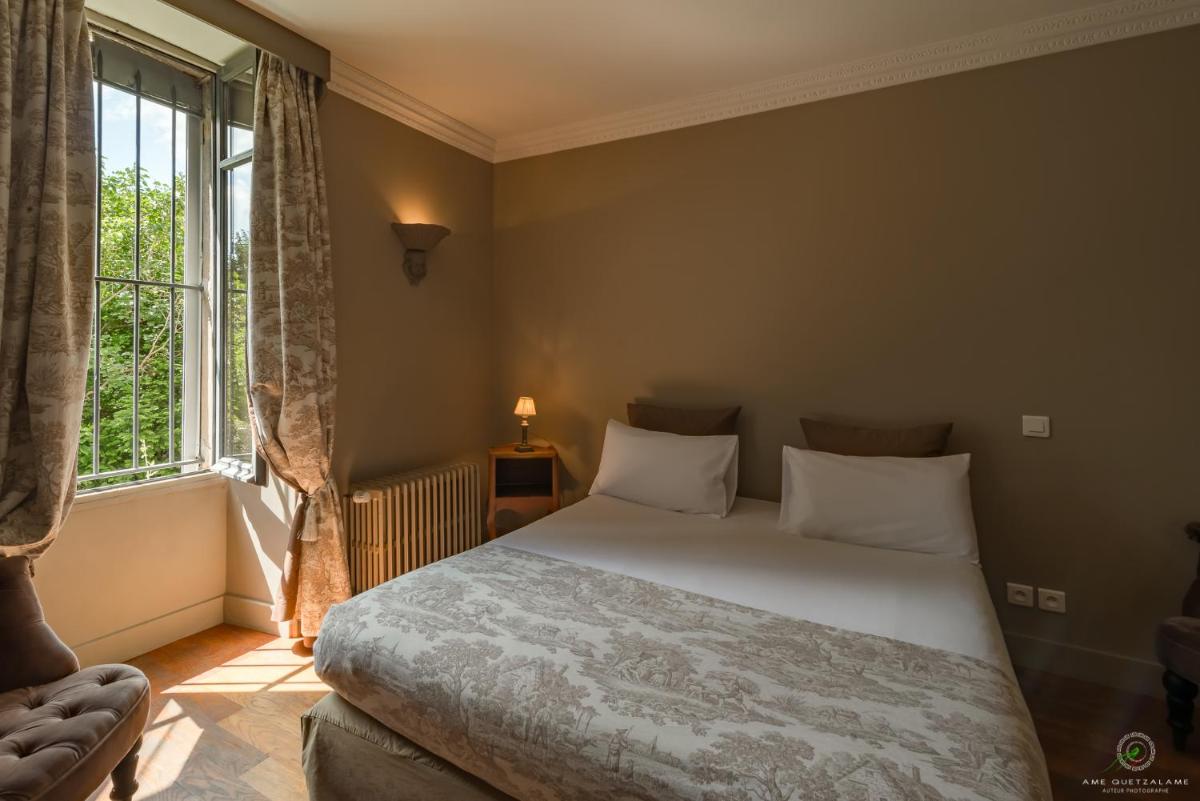 Un ou plusieurs lits dans un hébergement de l'établissement Hôtel Restaurant Spa Le Sauvage