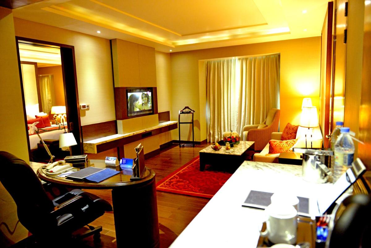 a room with a living room with a living room at Radisson Blu Jaipur in Jaipur