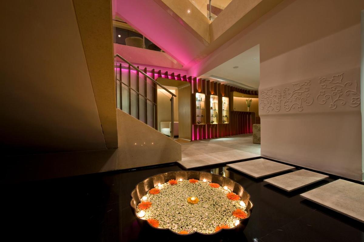 a dining room with a table in the middle of a building at Taj MG Road Bengaluru in Bengaluru a dining room with a table in the middle of a building at Taj MG Road Bengaluru in Bengaluru