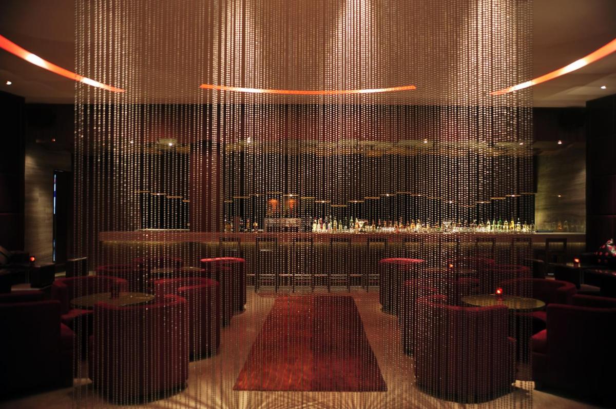 a room with tables and chairs and a large window at Taj Coromandel in Chennai