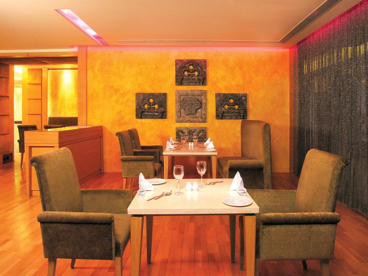 a dining room with a table and chairs and a table and chairsktop at Taj Chandigarh in Chandīgarh