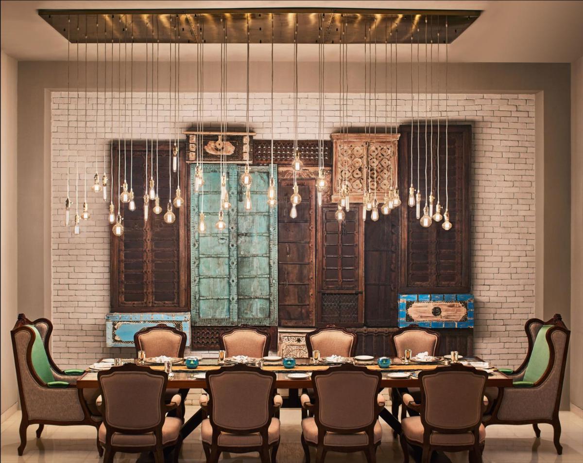 a dining room with a large table and chairs at Taj Aravali Resort & Spa Udaipur in Udaipur