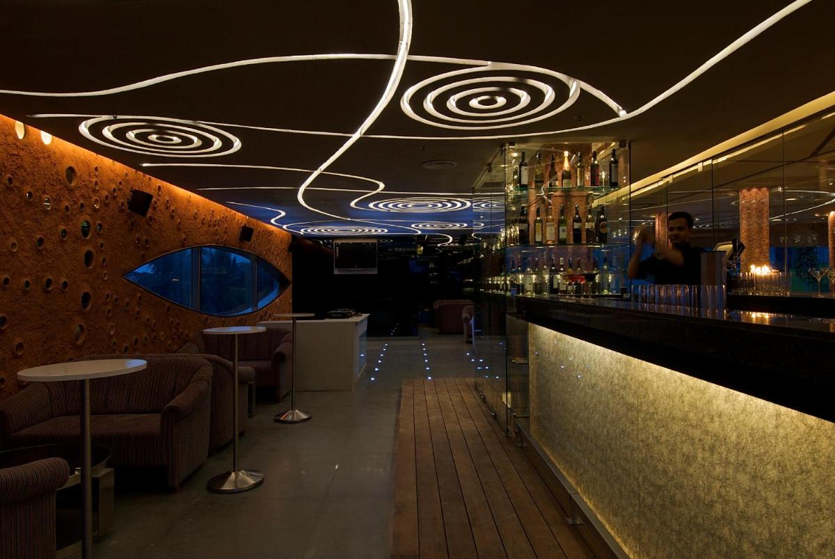 a bar with a person standing at the counter at Vivanta Bengaluru, Whitefield in Bengaluru