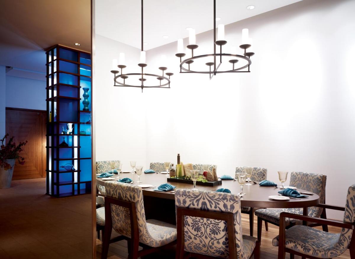 a dining room with a table and chairs and a chandelier at Taj Yeshwantpur Bengaluru in Bengaluru a dining room with a table and chairs and a chandelier at Taj Yeshwantpur Bengaluru in Bengaluru