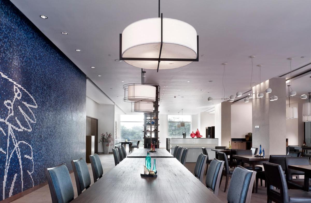 a dining room with a long table and chairs at Taj Yeshwantpur Bengaluru in Bengaluru a dining room with a long table and chairs at Taj Yeshwantpur Bengaluru in Bengaluru