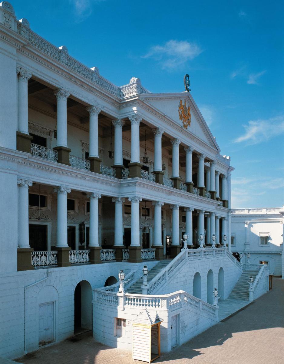 a large white building with white columns at Taj Falaknuma Palace in Hyderabad