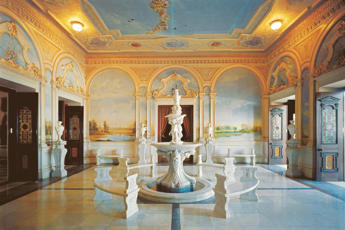 a building with a fountain in the middle of a room at Taj Falaknuma Palace in Hyderabad