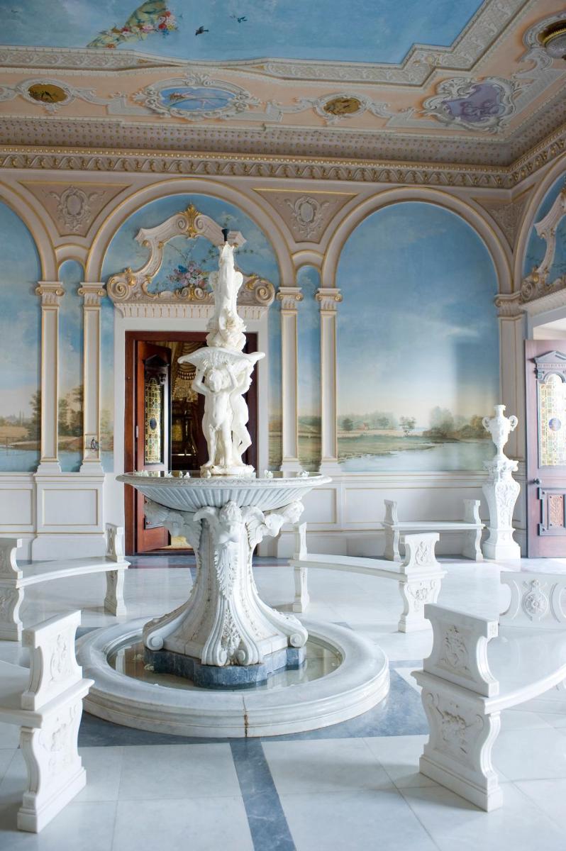 a white room with a fountain in the middle of it at Taj Falaknuma Palace in Hyderabad