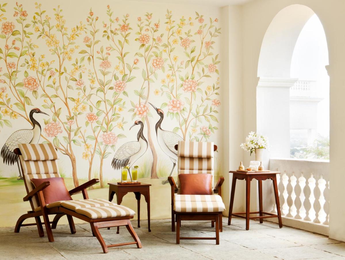 a living room with a wallpaper of birds at Taj Falaknuma Palace in Hyderabad
