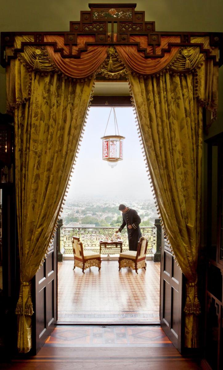a man standing in the doorway of a room at Taj Falaknuma Palace in Hyderabad