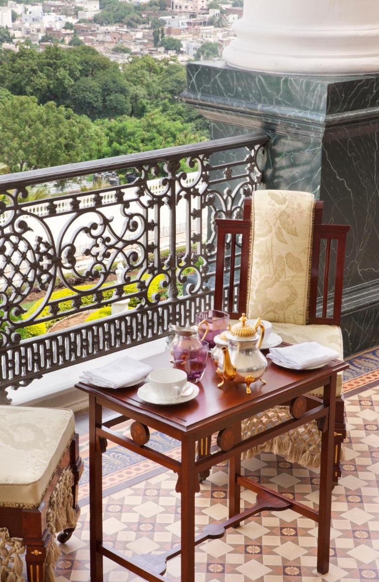 a table and two chairs on a balcony at Taj Falaknuma Palace in Hyderabad
