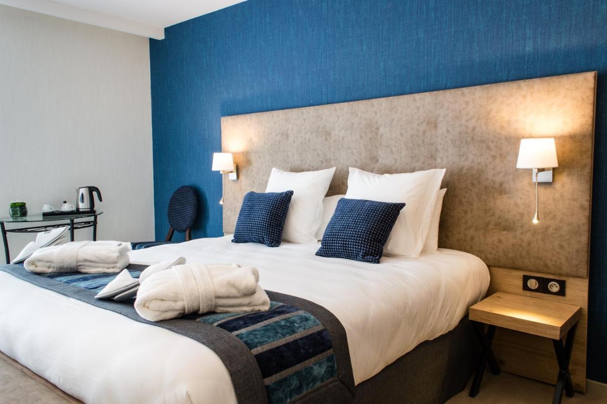 Un ou plusieurs lits dans un hébergement de l'établissement Hôtel Le Rive Droite & SPA