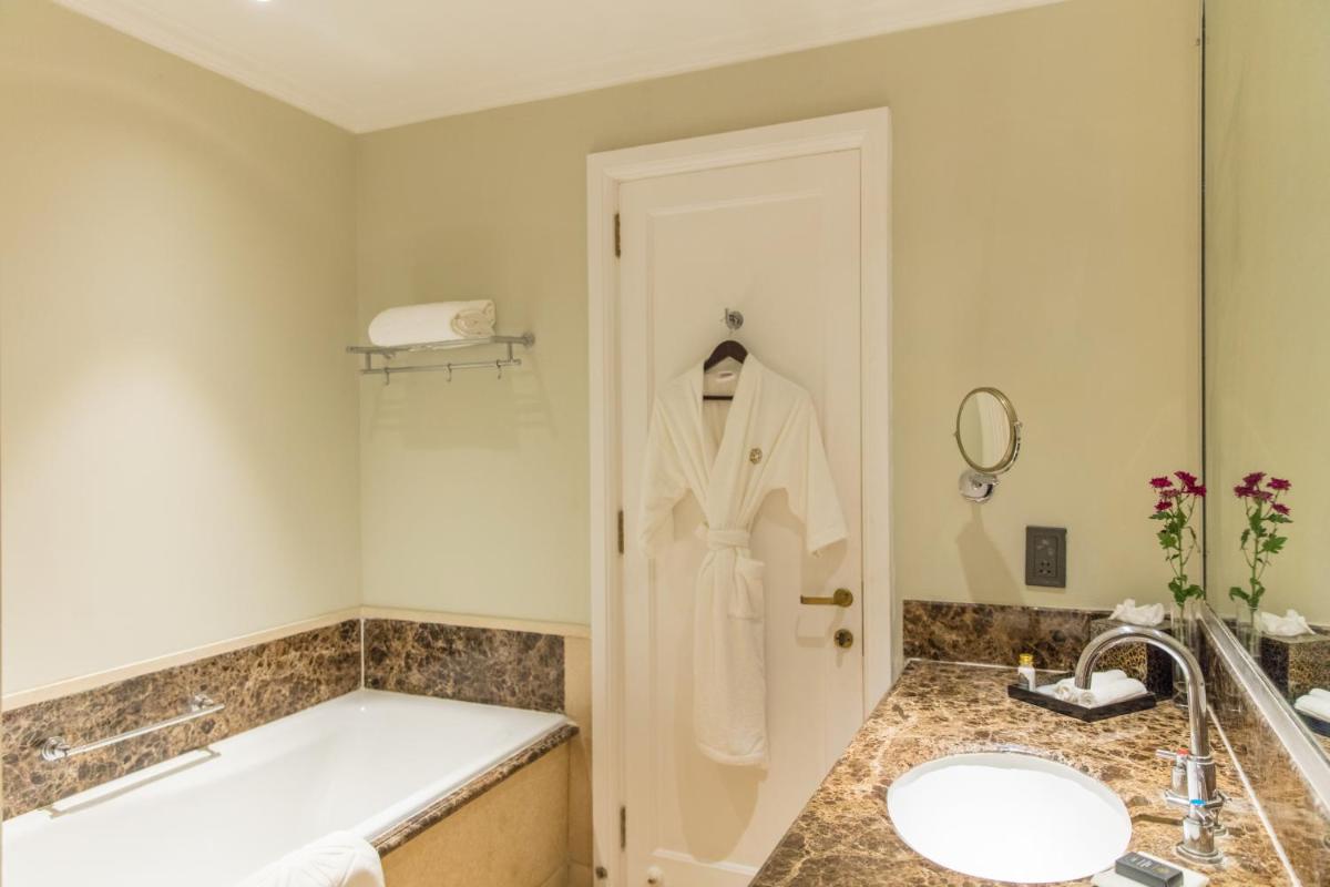 a bathroom with a bath tub and a sink at Taj Connemara, Chennai in Chennai