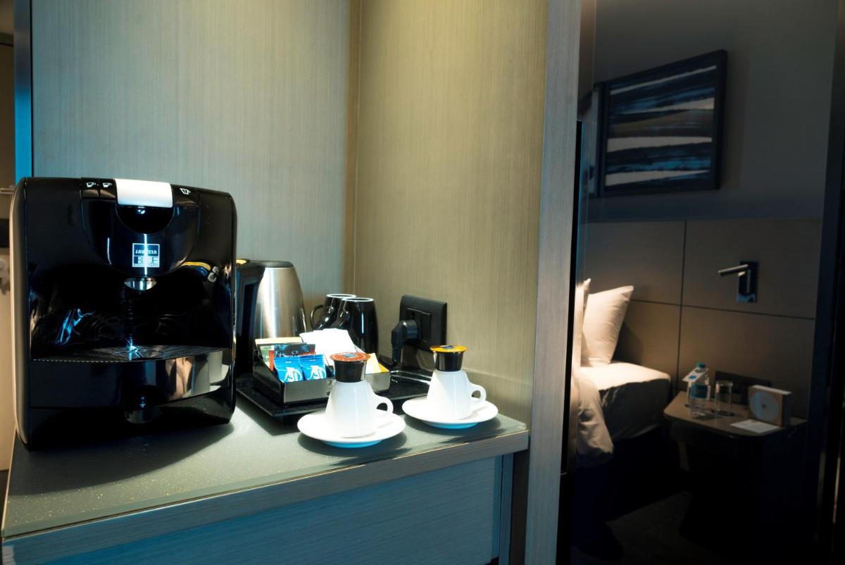 a coffee machine on a counter in a hotel room at Novotel Chennai Chamiers Road in Chennai