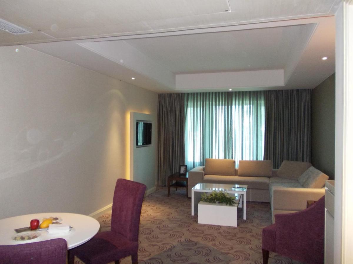 a living room with a couch and a table at Radisson Hyderabad Hitec City in Hyderabad