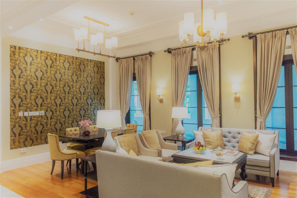 a living room with a couch and a table at Taj Connemara, Chennai in Chennai