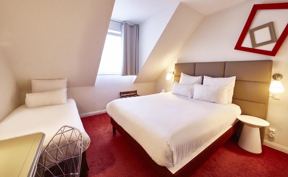 Un ou plusieurs lits dans un hébergement de l'établissement Best Western Plus Au cheval Blanc à Mulhouse