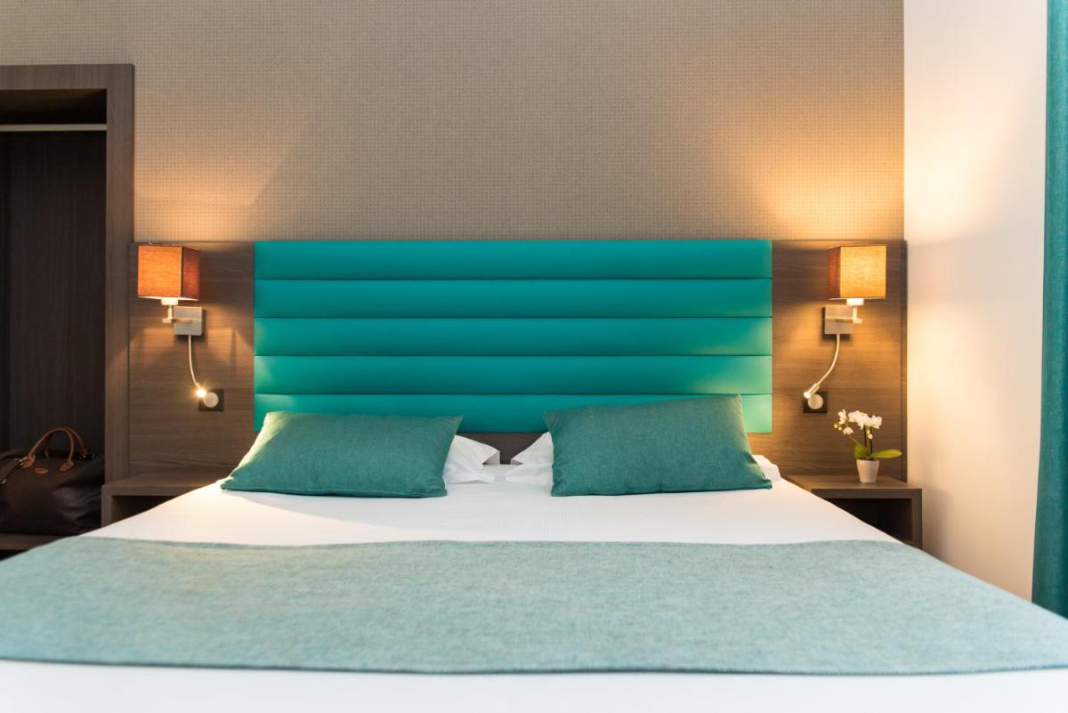 Un ou plusieurs lits dans un hébergement de l'établissement Hôtel Lutétia & Spa