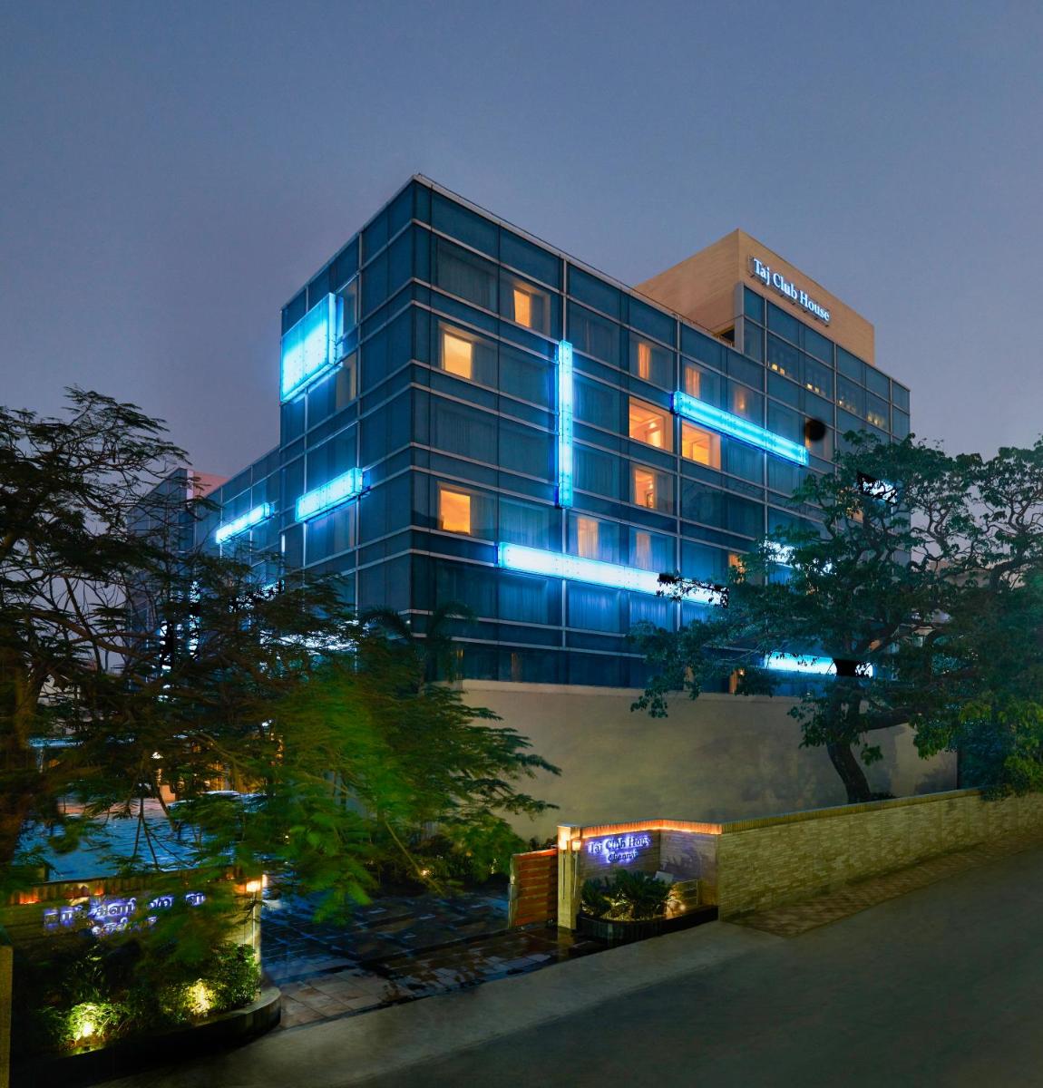 a building with blue lights on it at night at Taj Club House in Chennai a building with blue lights on it at night at Taj Club House in Chennai
