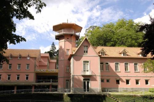 um grande edifício com uma torre no topo em Palace Hotel & Spa - Termas de Sao Vicente em Penafiel