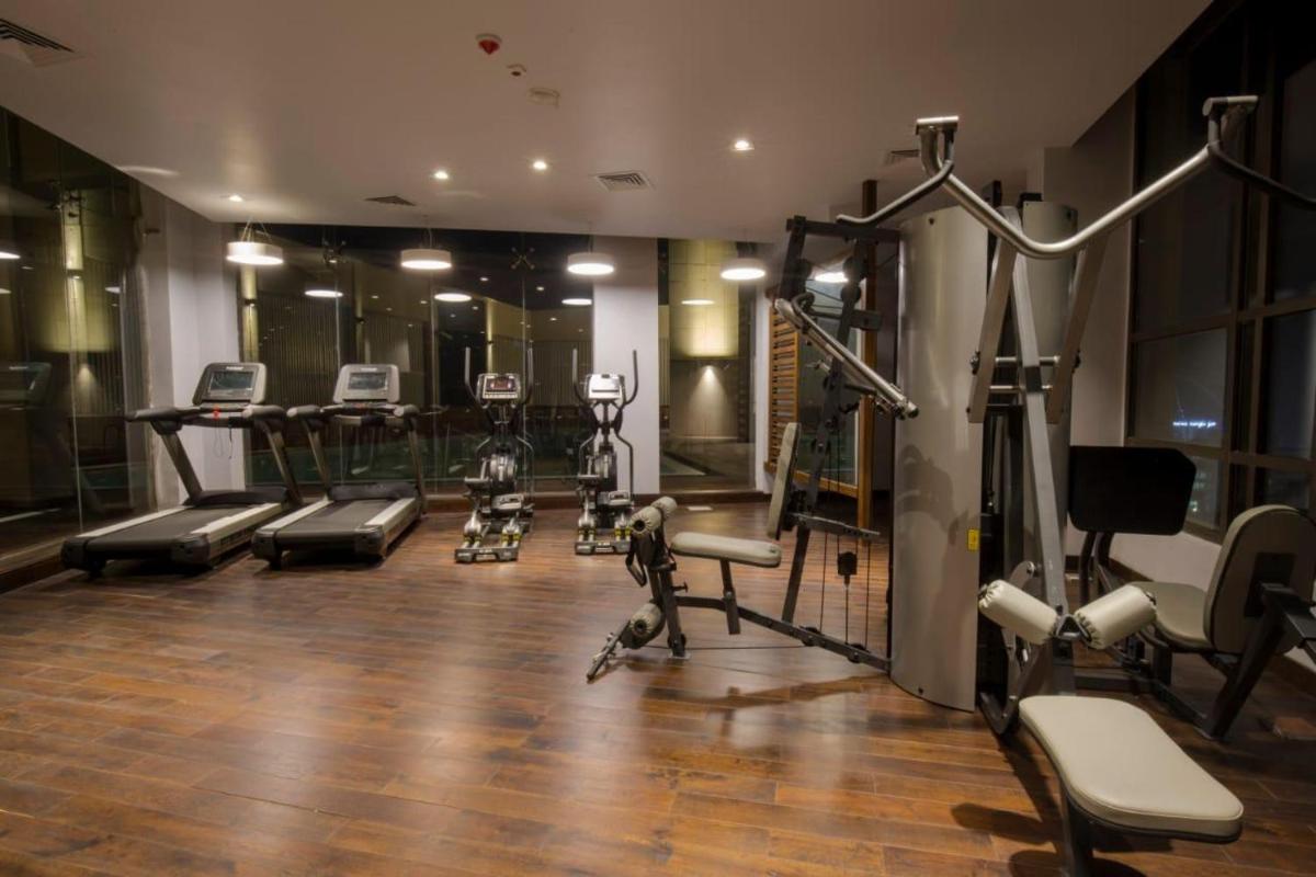 a gym with several exercise equipment in a room at Zone By The Park Kolkata, Newtown in Kolkata