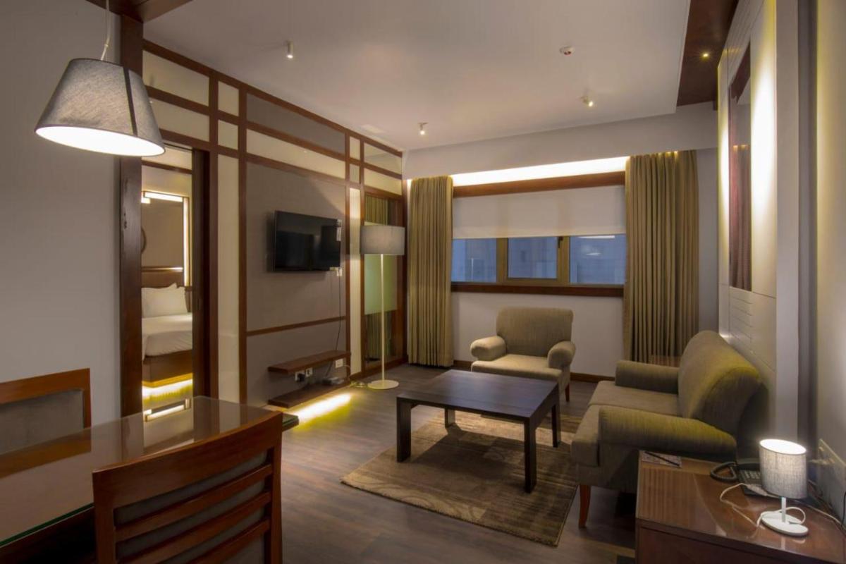 a living room with a couch chair and a table at Zone By The Park Kolkata, Newtown in Kolkata