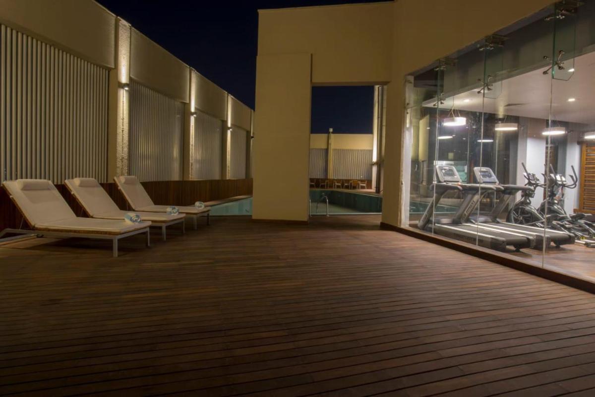 a room with a row of chairs and a pool at Zone By The Park Kolkata, Newtown in Kolkata