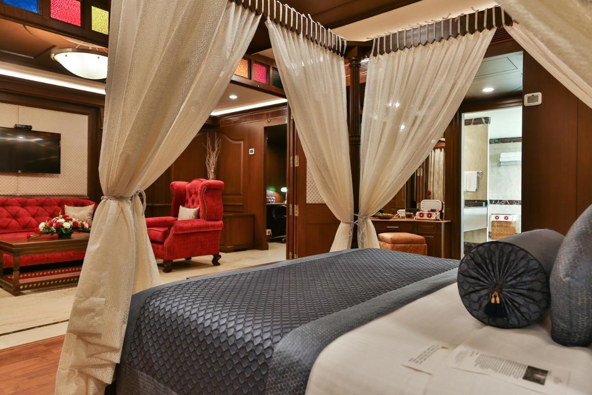 a bedroom with a bed and a living room at The Accord Metropolitan in Chennai