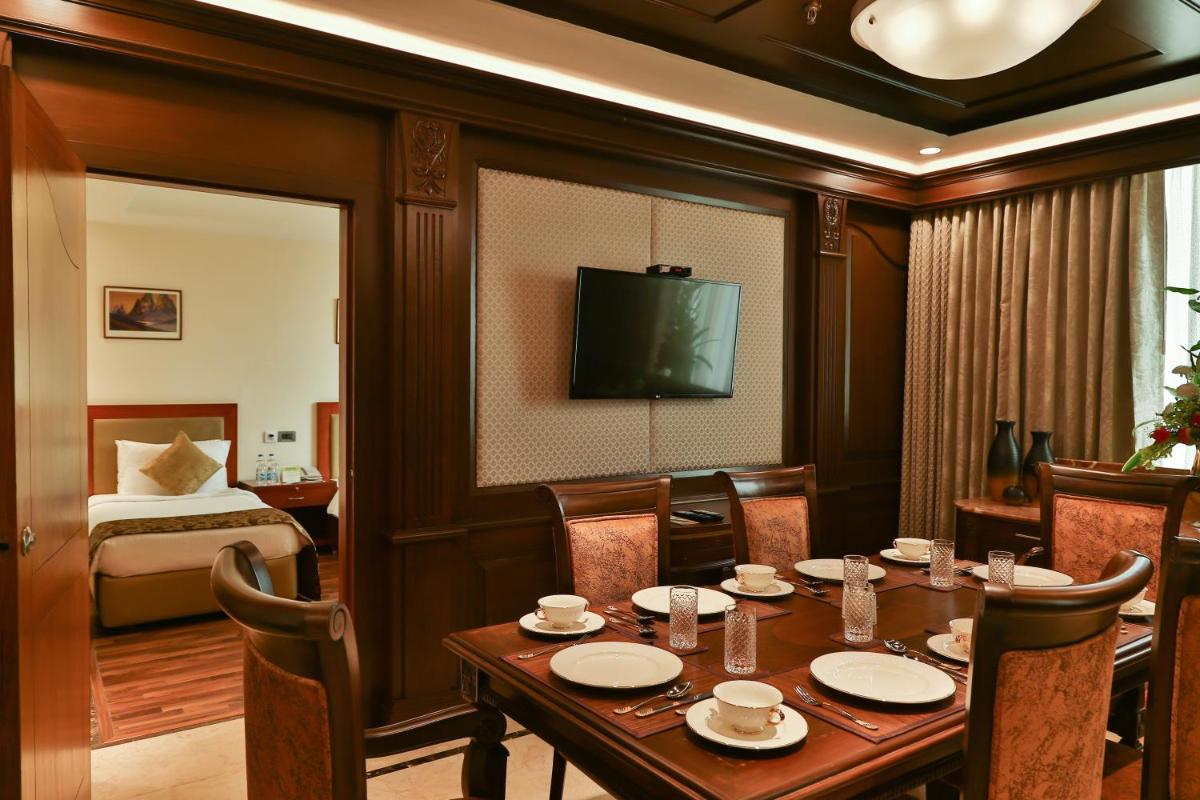 a hotel room with a table and a bed at The Accord Metropolitan in Chennai
