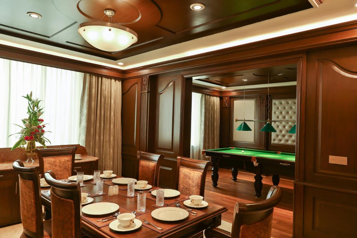 a dining room with a table and a pool table at The Accord Metropolitan in Chennai